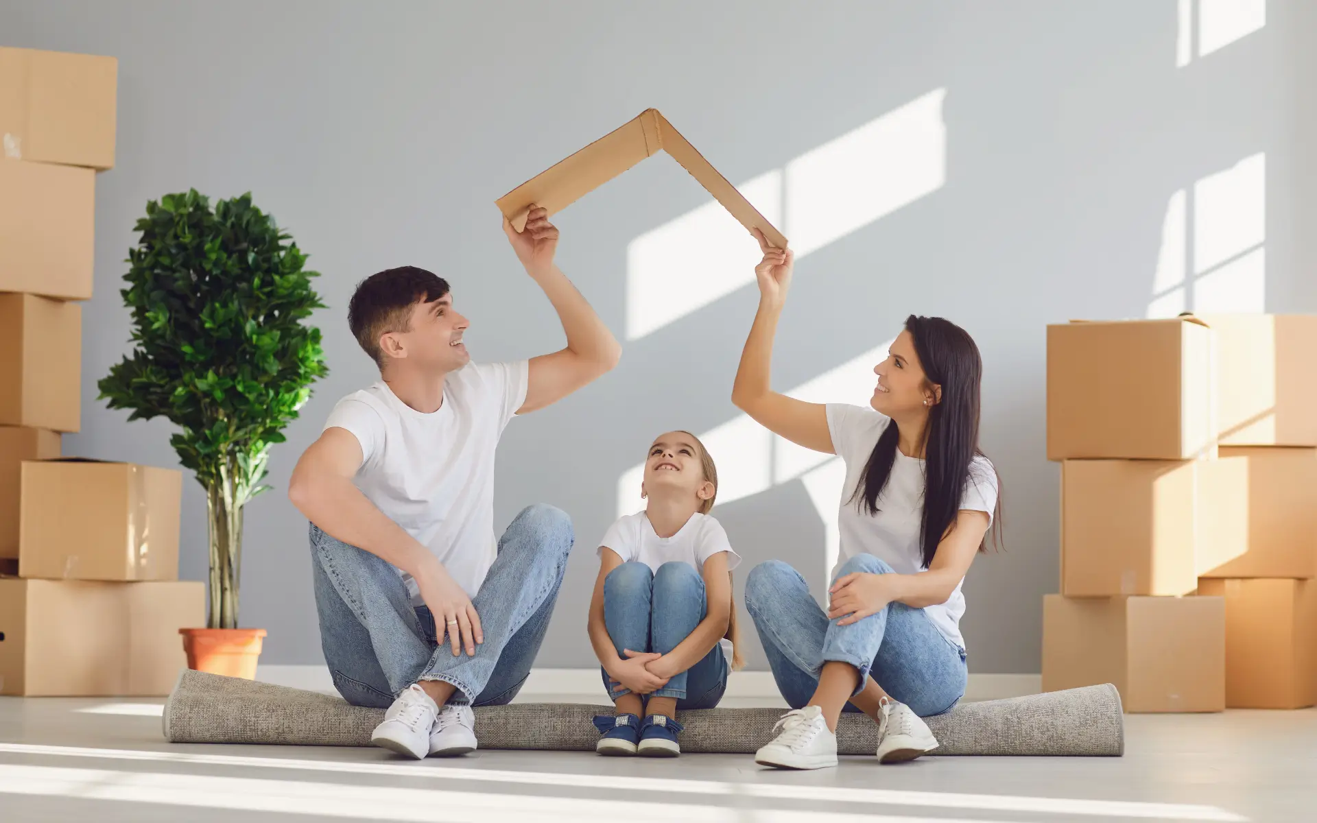 Happy family making a house shape, symbolizing homeownership and mortgage advice.
