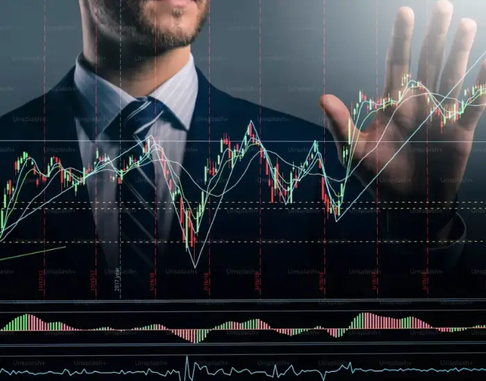 A person in a suit interacting with an overlaid financial candlestick chart.